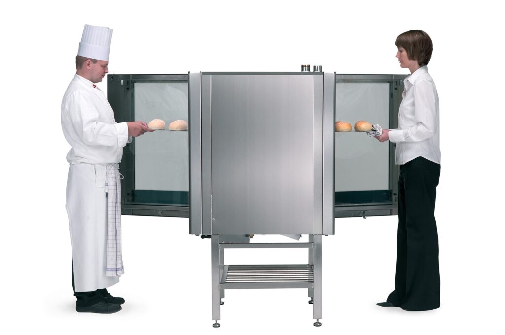 chef & waiter on on opposite sides of passthrough oven with doors open